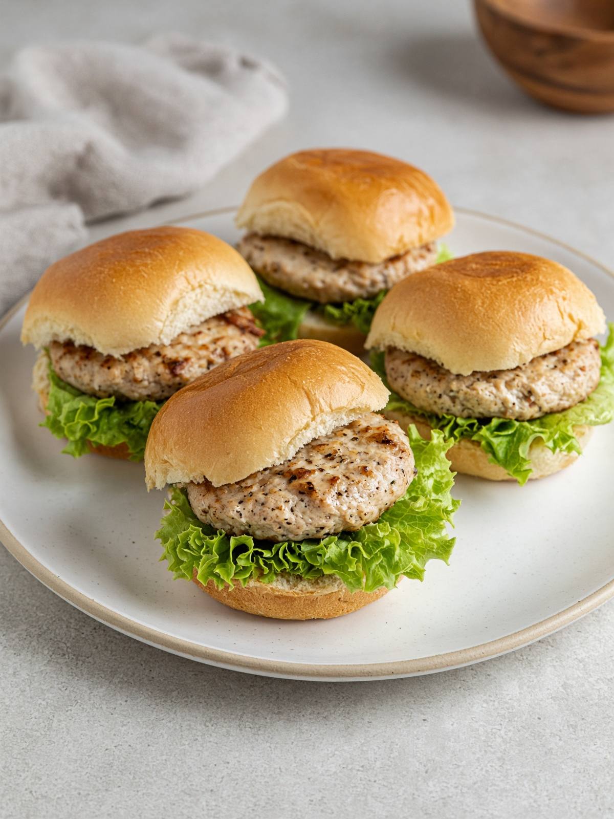A turkey burger on a bun with lettuce.
