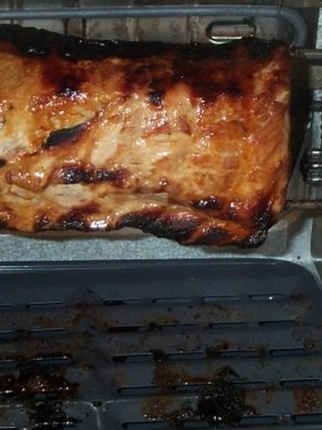 Sliced garlic herb pork tenderloin resting on a cutting board