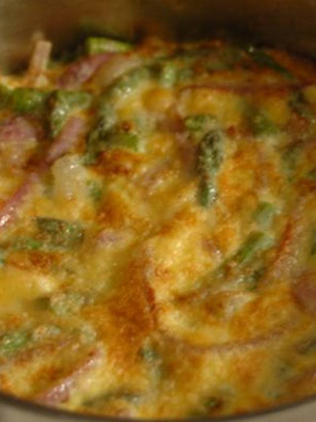 Sliced asparagus gruyere frittata on a plate