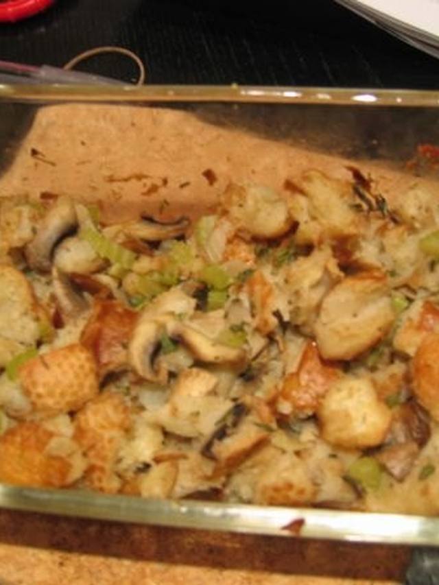 Roasted chicken thighs on herbed stuffing in a baking dish