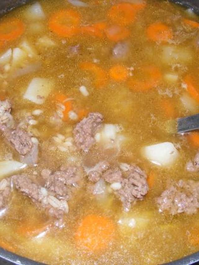 Hearty beef barley soup with carrots and celery in a bowl