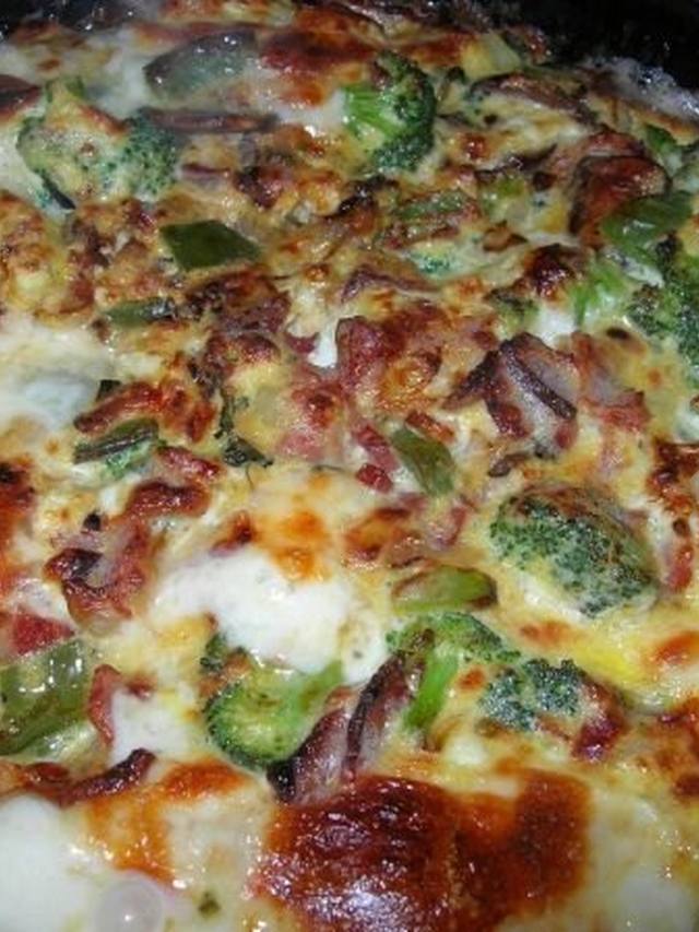 Sliced broccoli cheddar frittata on a white plate