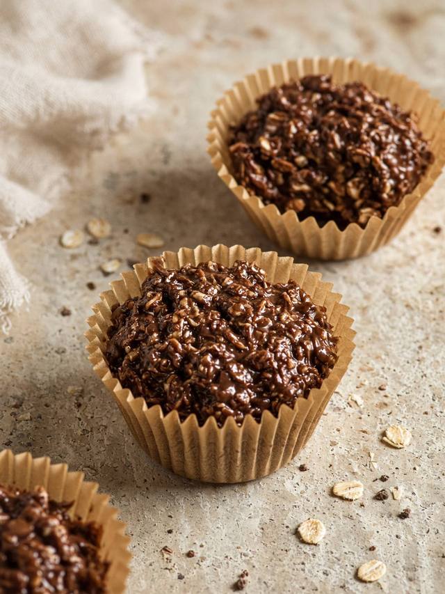 No-bake chocolate oat cups in paper liners, set firm from the fridge.