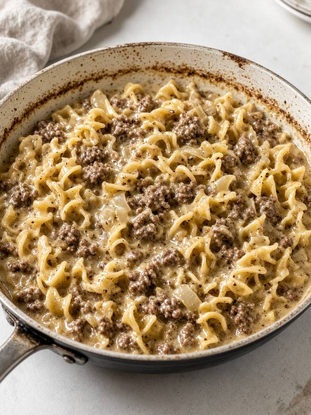 Creamy ground beef and egg noodles in a skillet.