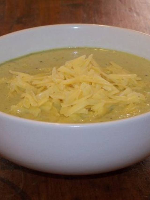 Thick broccoli cheddar soup in a bowl with visible broccoli pieces