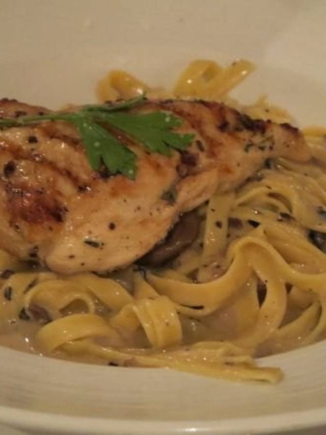 Fettuccine in creamy mushroom sauce with parsley on top