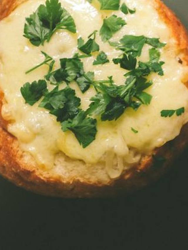Onion soup in an oven-safe bowl topped with melted cheese and toast