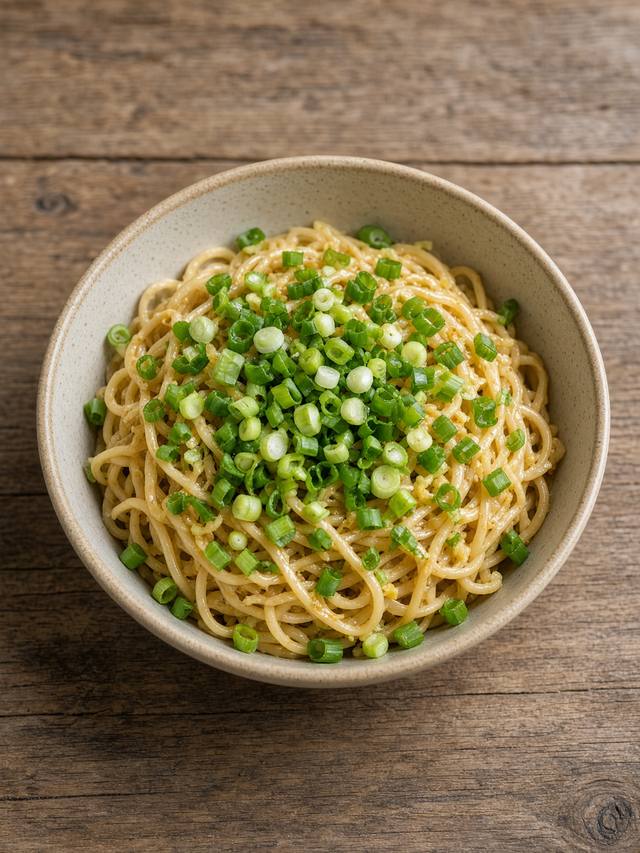 Noodles glossy with ginger scallion oil and a jammy egg