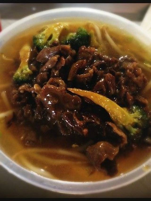 Bowls of beef ramen with egg, scallion, and noodles