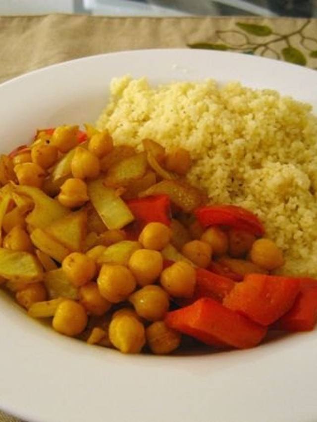 Bowl of couscous and harissa chickpeas with yogurt