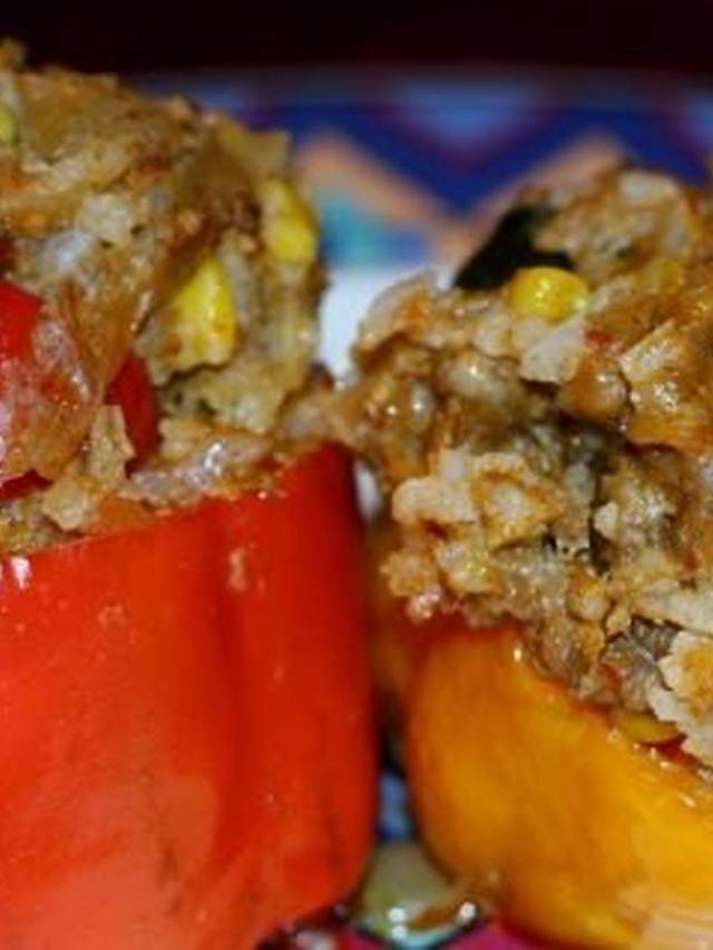 Baked bell peppers stuffed with quinoa, tomato, and feta
