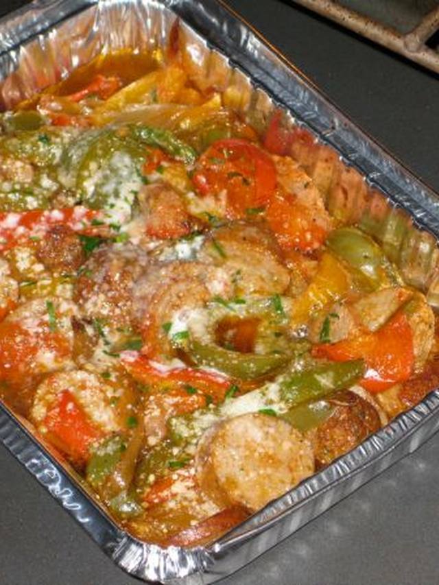 Skillet of browned sausage coins with peppers and onions