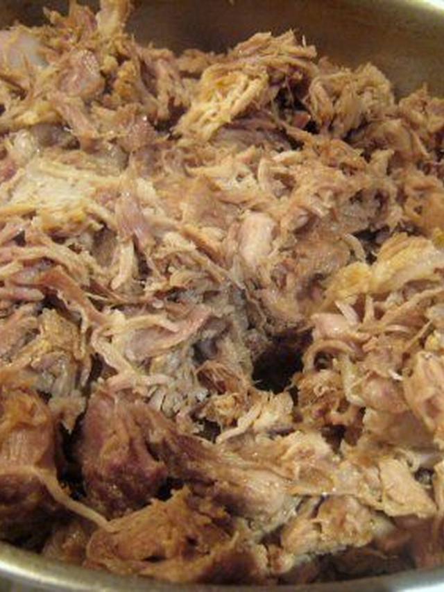 Shredded pork carnitas with crispy edges on a platter