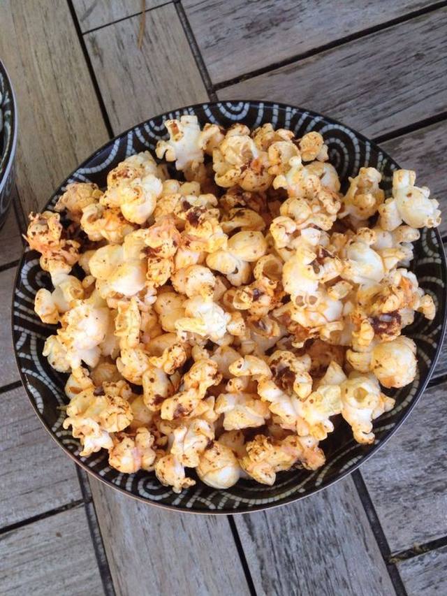 Bowl of chili lime popcorn with visible zest