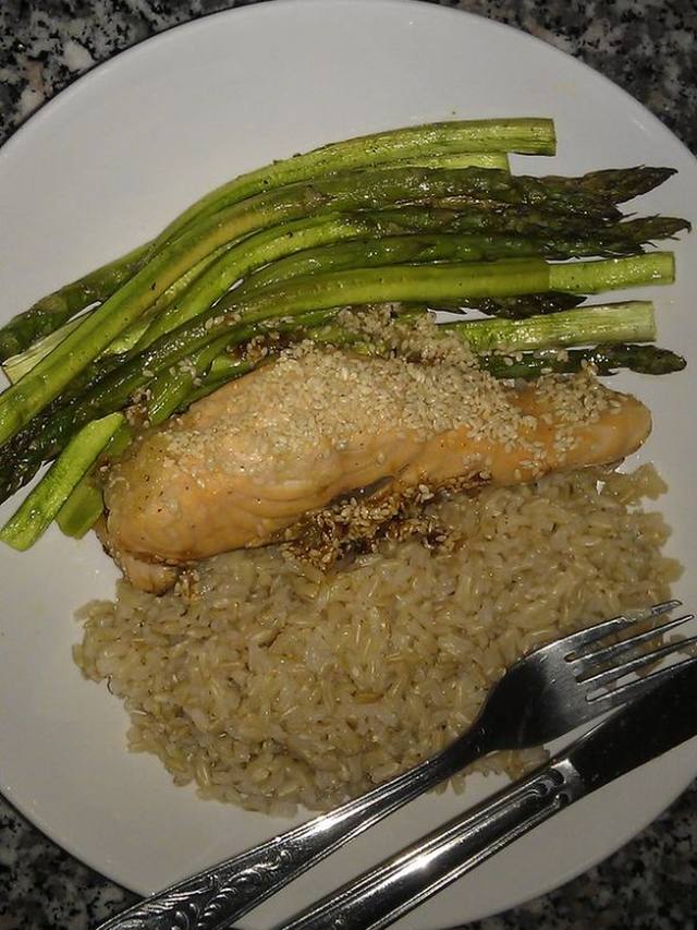 Glazed salmon fillets with shiny soy ginger sauce in a skillet