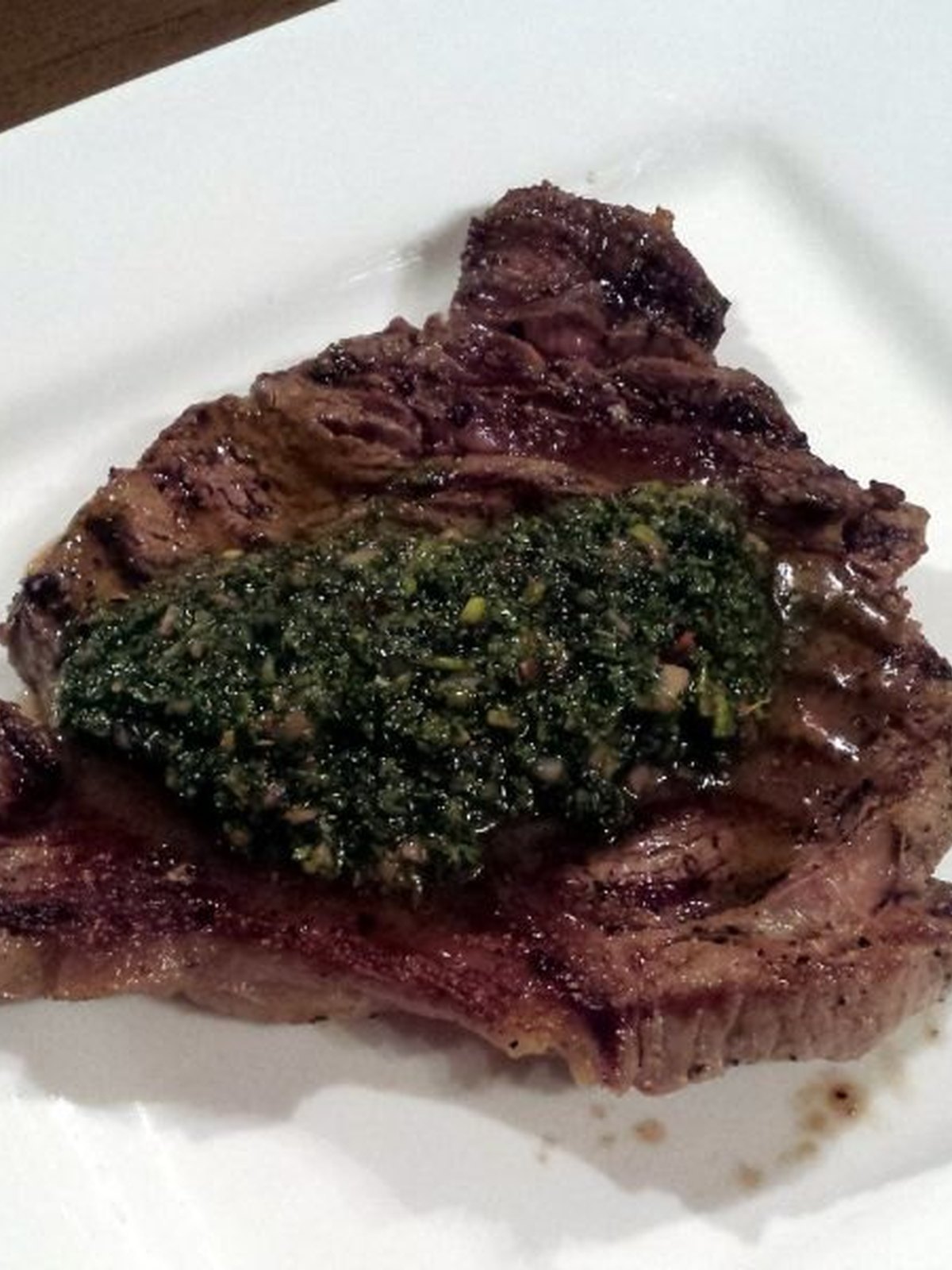Sliced steak salad with green chimichurri sauce