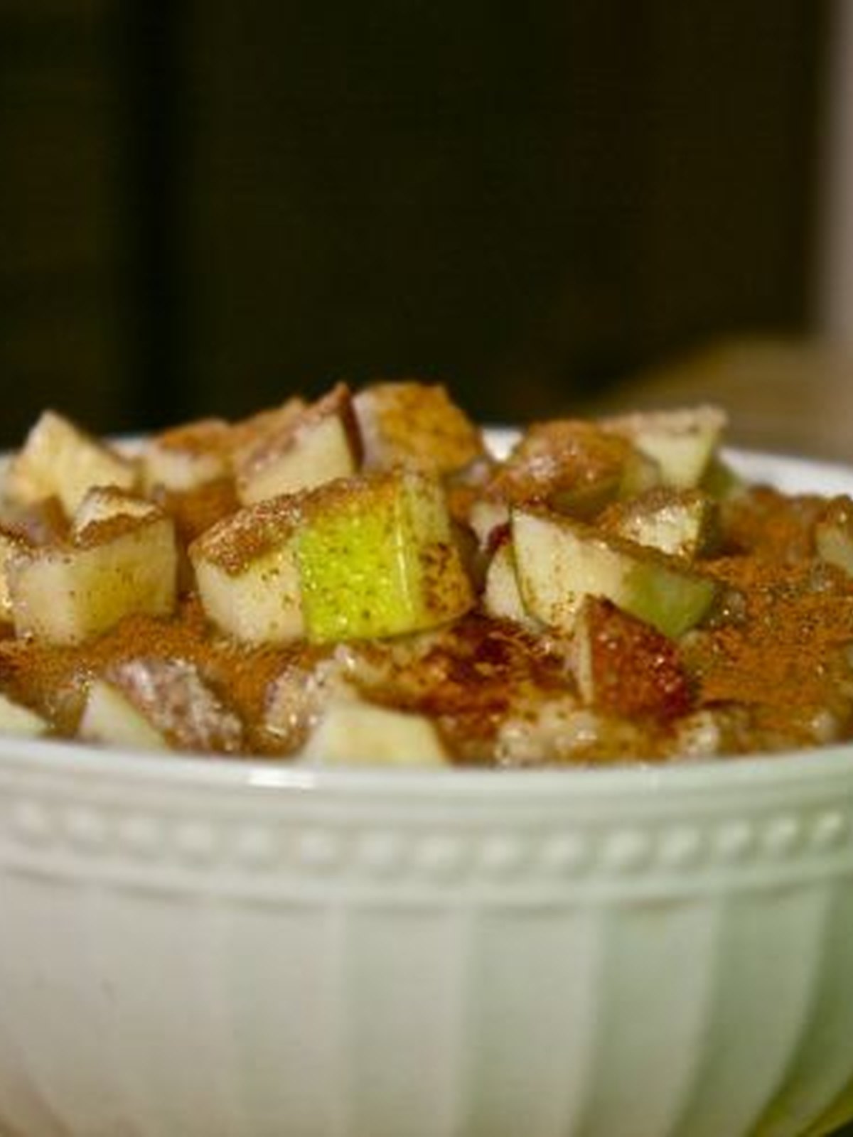 Bowl of cinnamon apple oatmeal topped with diced apple