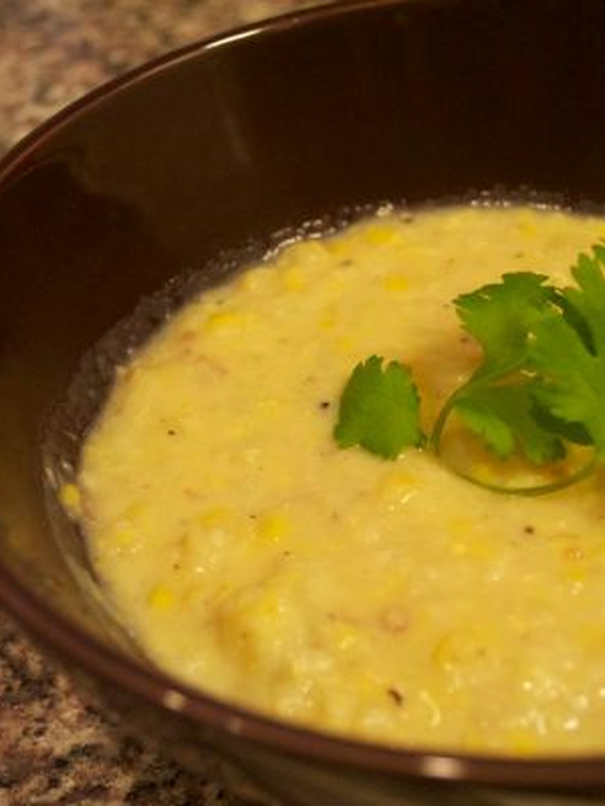Creamy corn and potato chowder in a white bowl