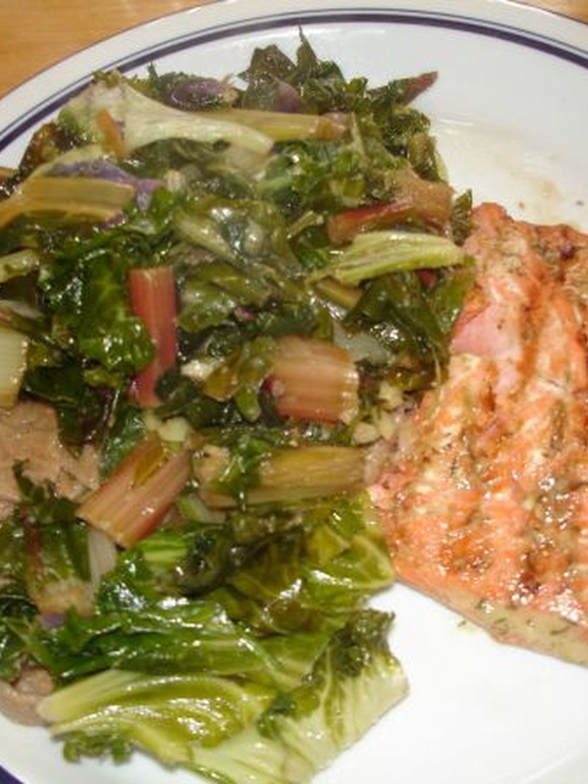 Bowl of lemon dill salmon salad with cucumber slices and fresh dill