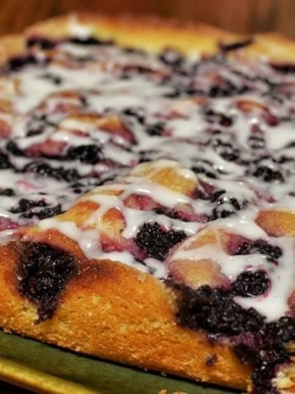 Golden peach blackberry cobbler in a baking dish with bubbling fruit edges