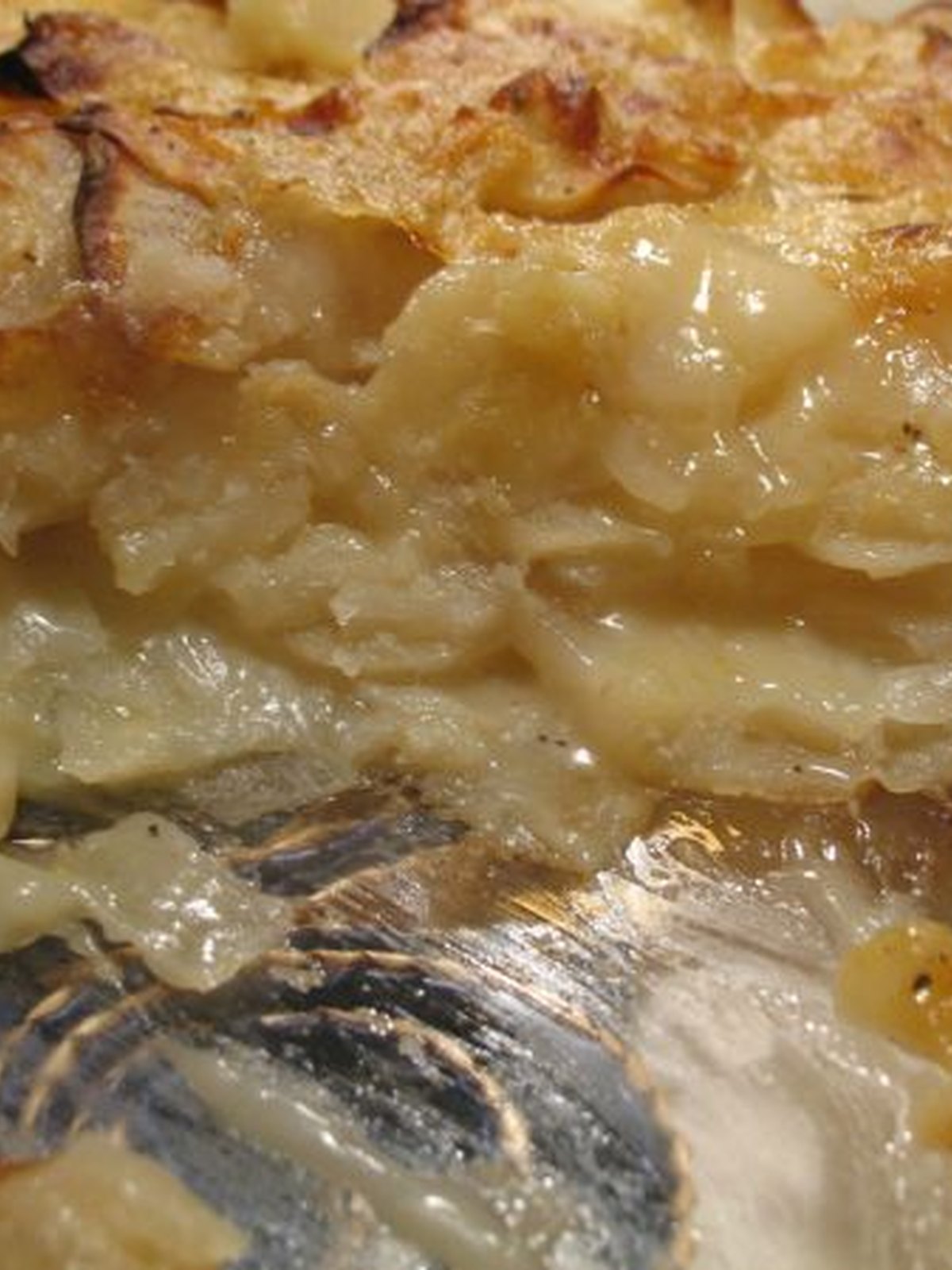A baking dish of scalloped potatoes with a browned top