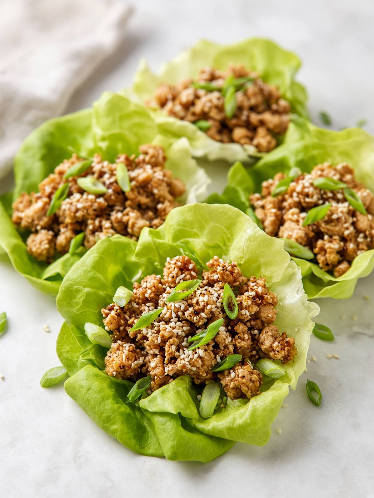 Butter lettuce cups filled with sesame ground chicken.