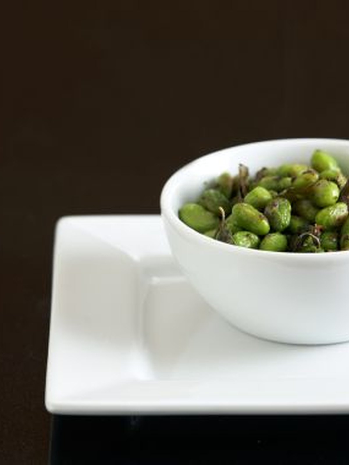 Bowl of blistered spicy air-fried edamame pods