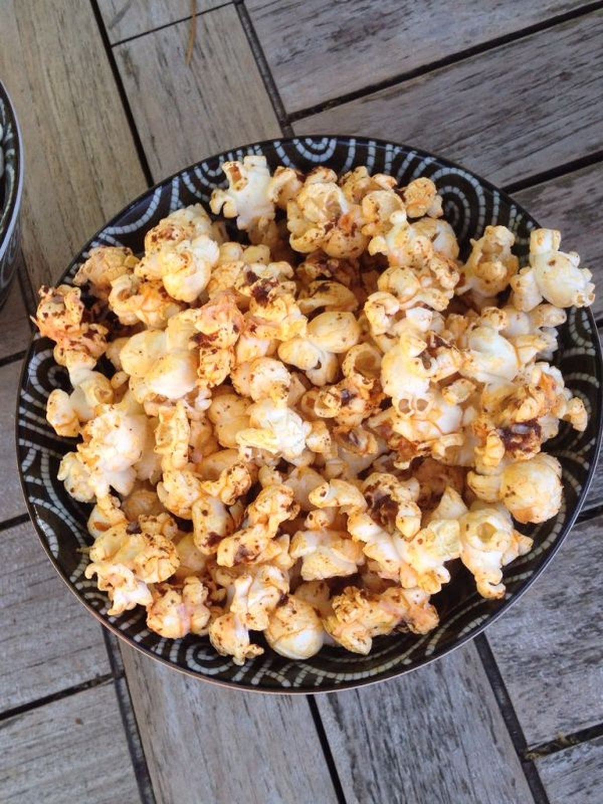 Bowl of chili lime popcorn with visible zest