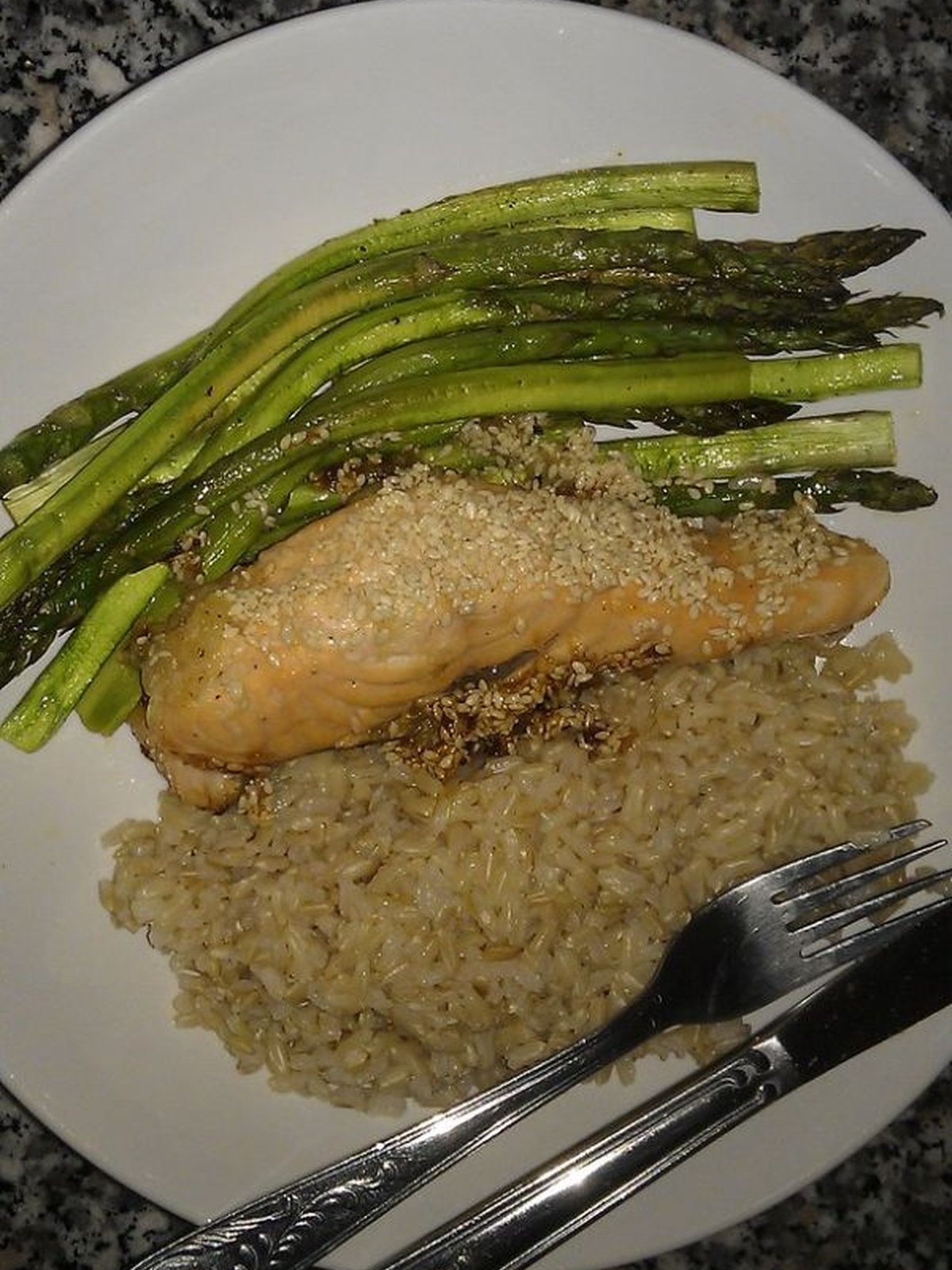 Glazed salmon fillets with shiny soy ginger sauce in a skillet