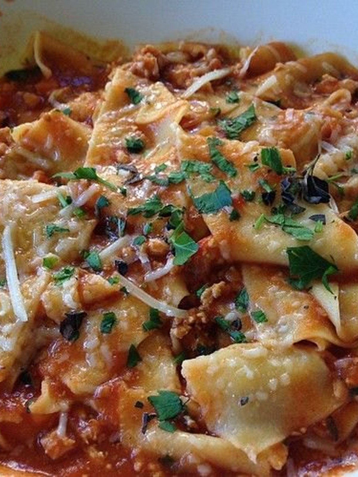 Rigatoni coated in turkey bolognese sauce with grated cheese