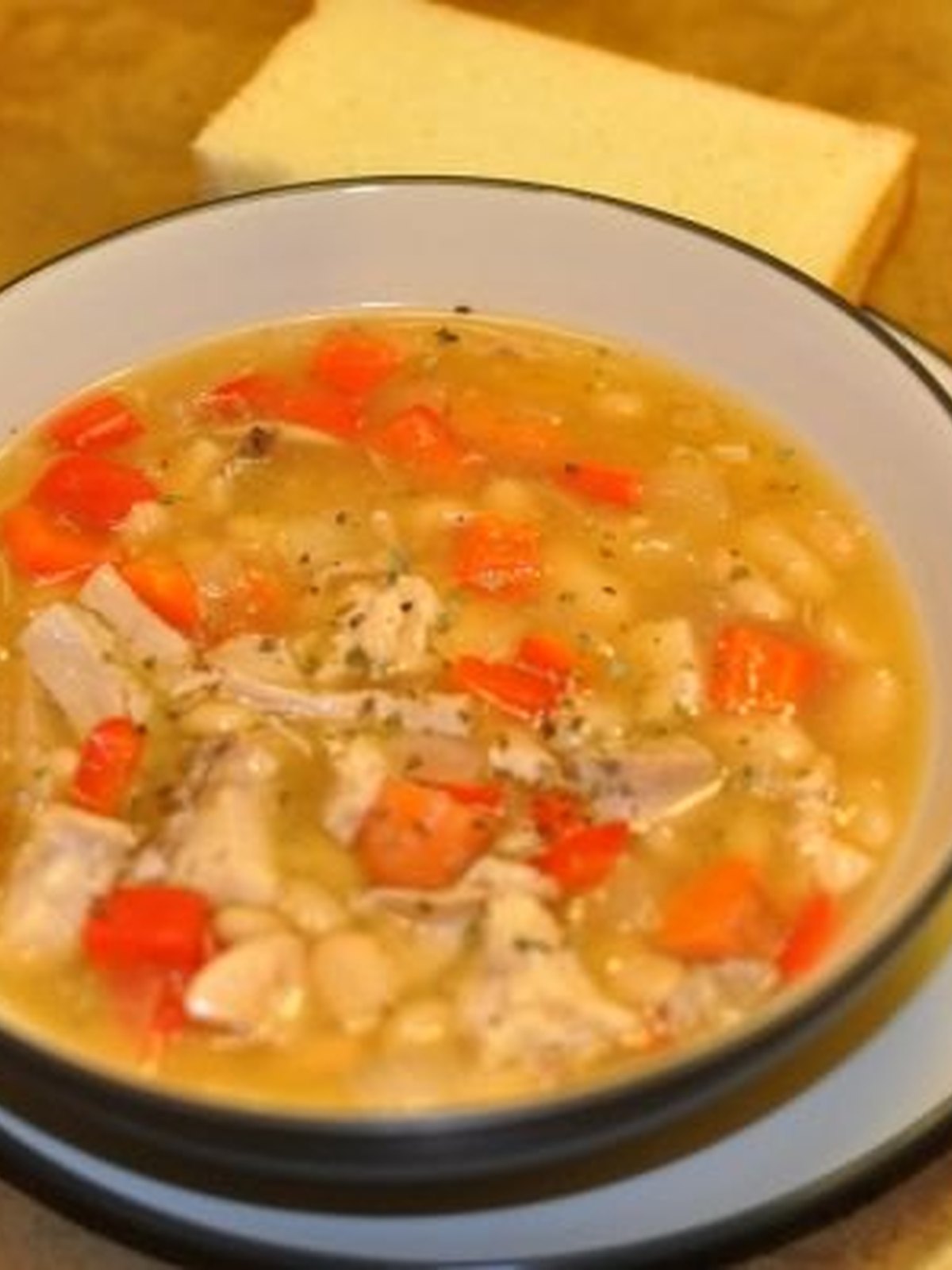 A bowl of turkey white bean chili with a spoon of yogurt